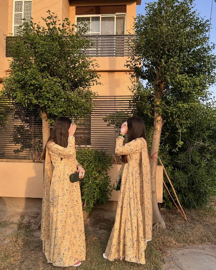 Sharing a quiet moment together in matching floral dresses