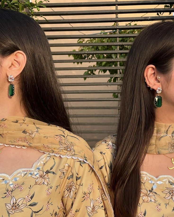 A close-up of matching earrings and floral outfits
